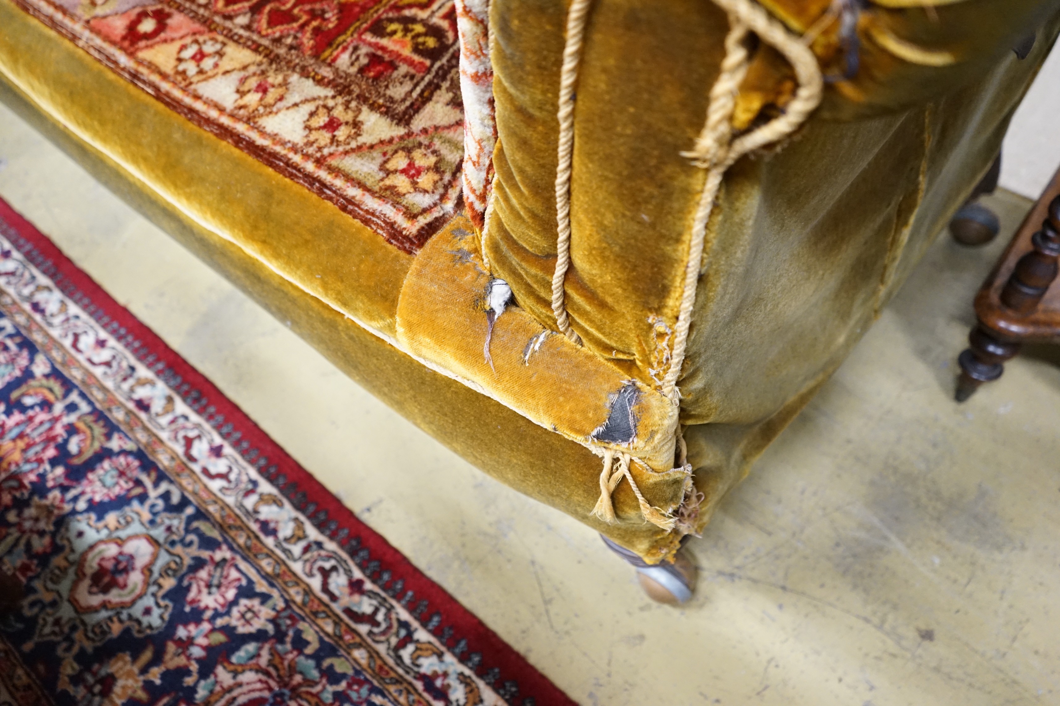 A late Victorian drop arm Chesterfield settee with carpet upholstery, length 175cm, width 78cm, height 80cm